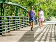 Picture of couple walking across the Green Bridge on Main Street