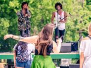 Picture of band playing while a lady dances