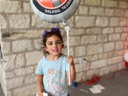 Picture of girl holding balloon at Music Friendly Community celebration