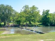 People swimming in Salado Creek at Sirena Park