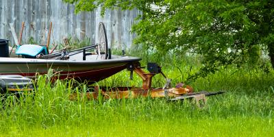 Code violation of a yard with high weeds and rusty boat with scraps