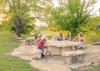 Kids sit around a picnic table at Sirena Park